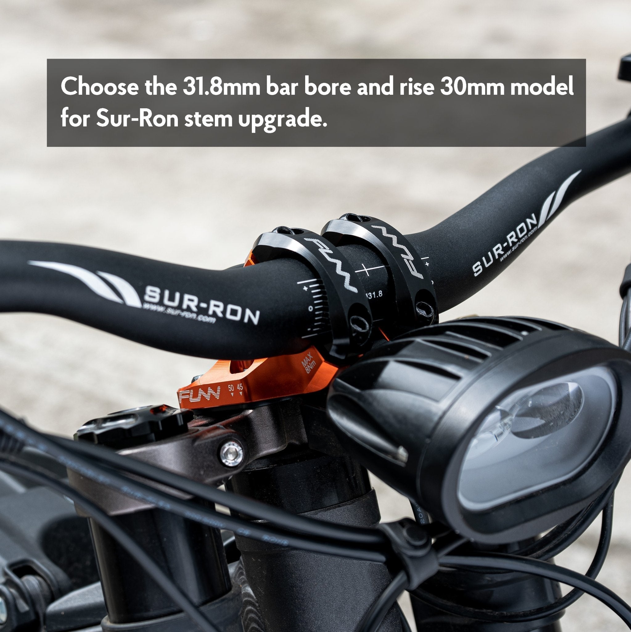 Funn RSX direct-mount stem in orange fitted to a Sur-Ron, clamping the stock 31.8mm handlebar