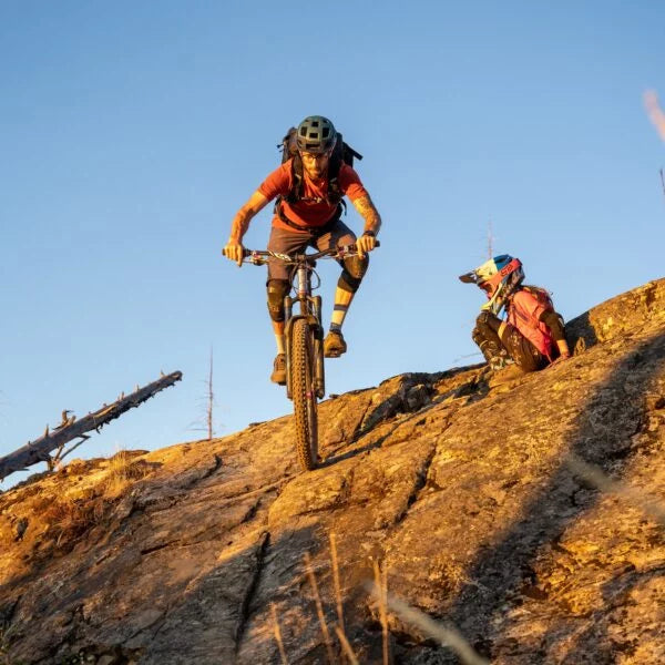 a mountain bike rider riding down a hill