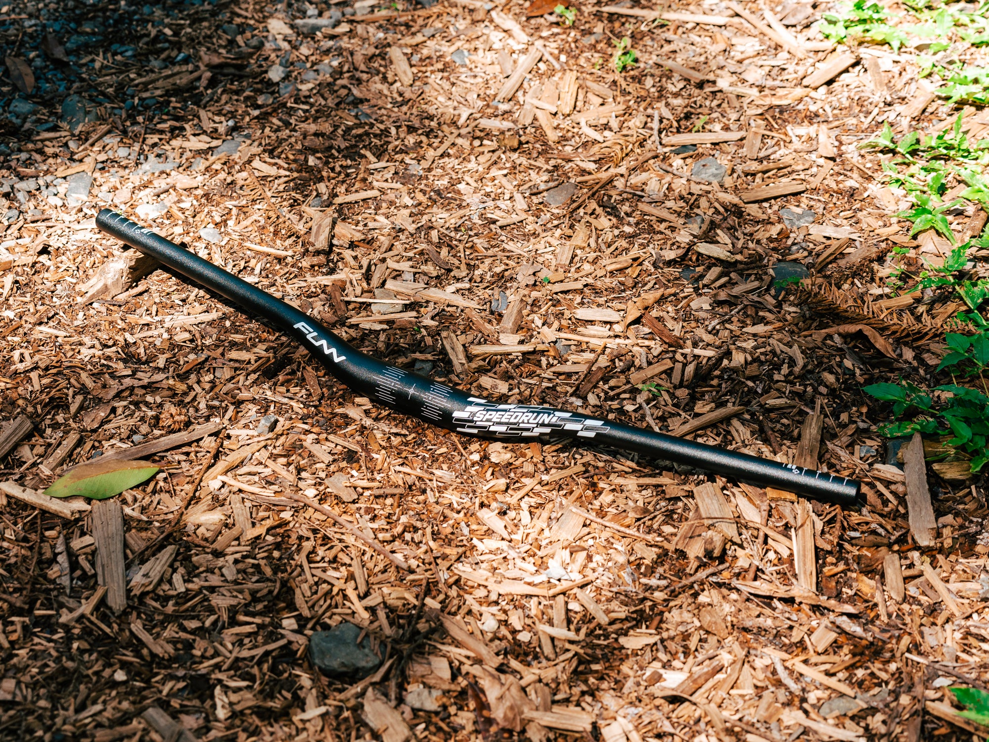 a black funn speedrun riser bicycle handlebar on the ground