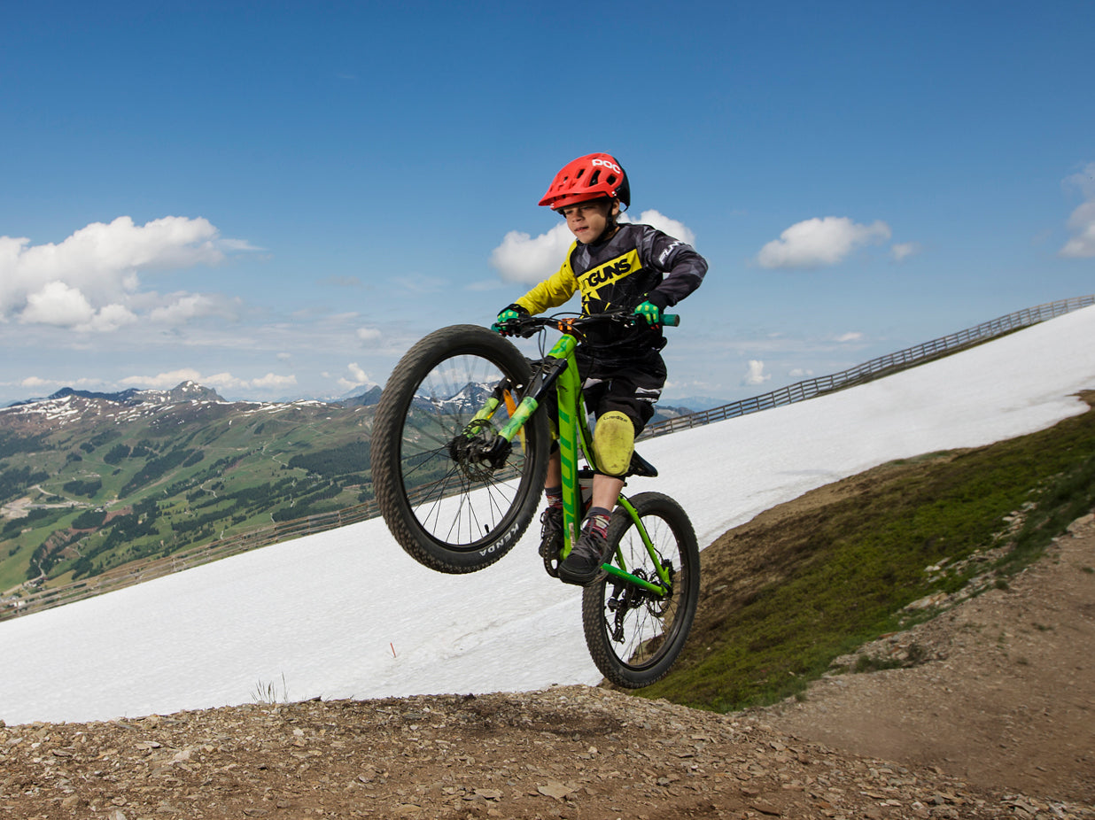 a young rider is riding on his mountain bike