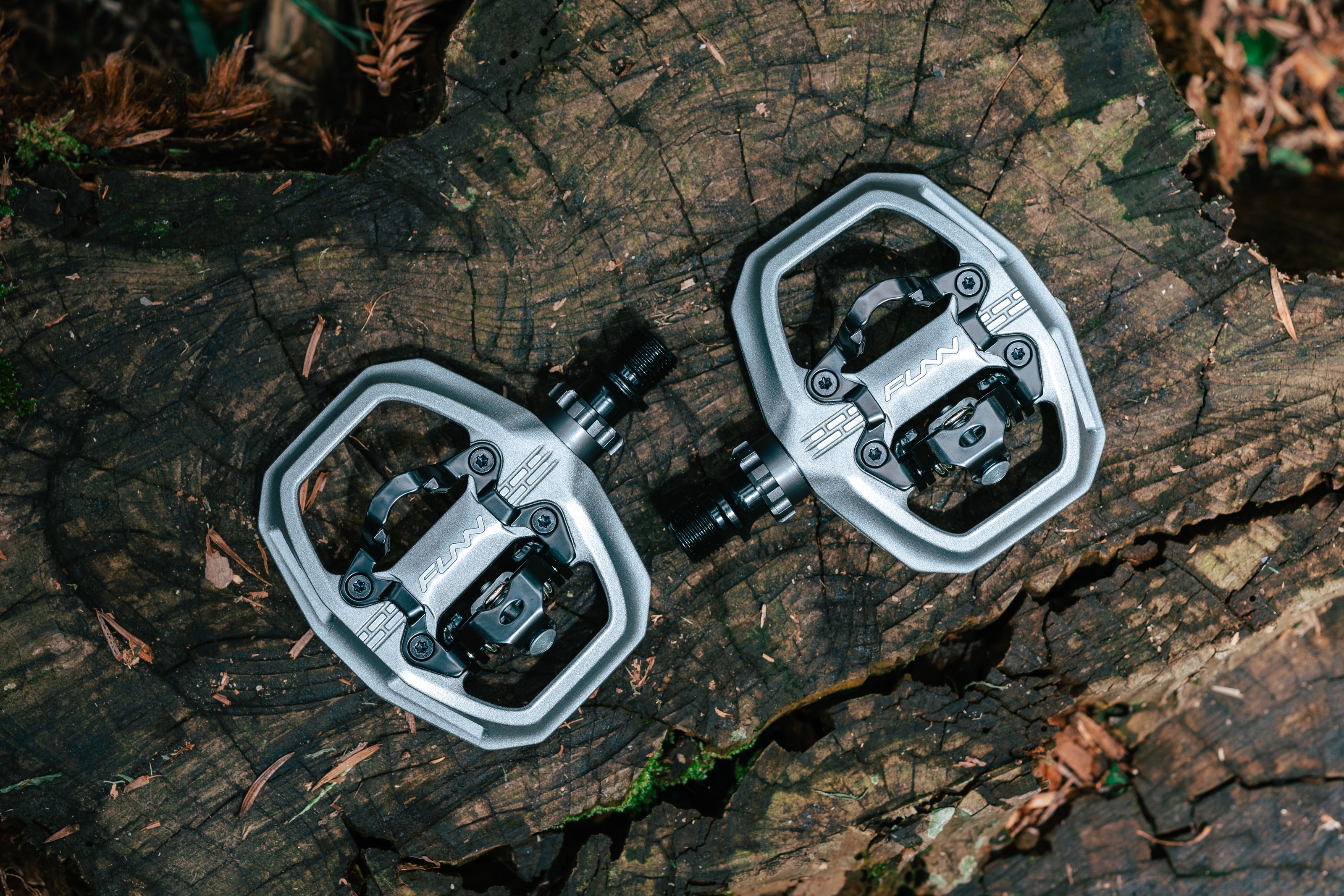 Pair of Funn Clast pedals on a wooden surface