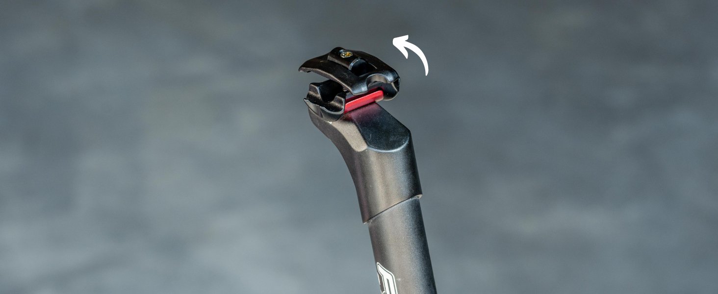 The image displays a bike seat post, with a close-up of the saddle top clamp pivoted 90°.slider_item_kn9NMb