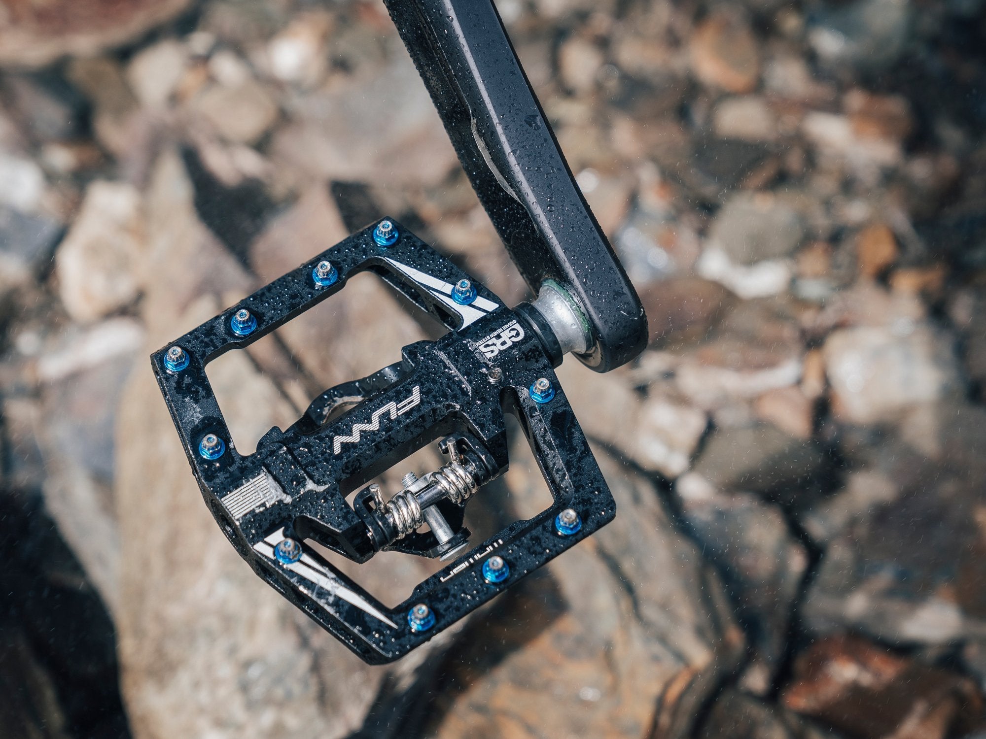 a black funn mamba single sided clipless pedals on a crankset