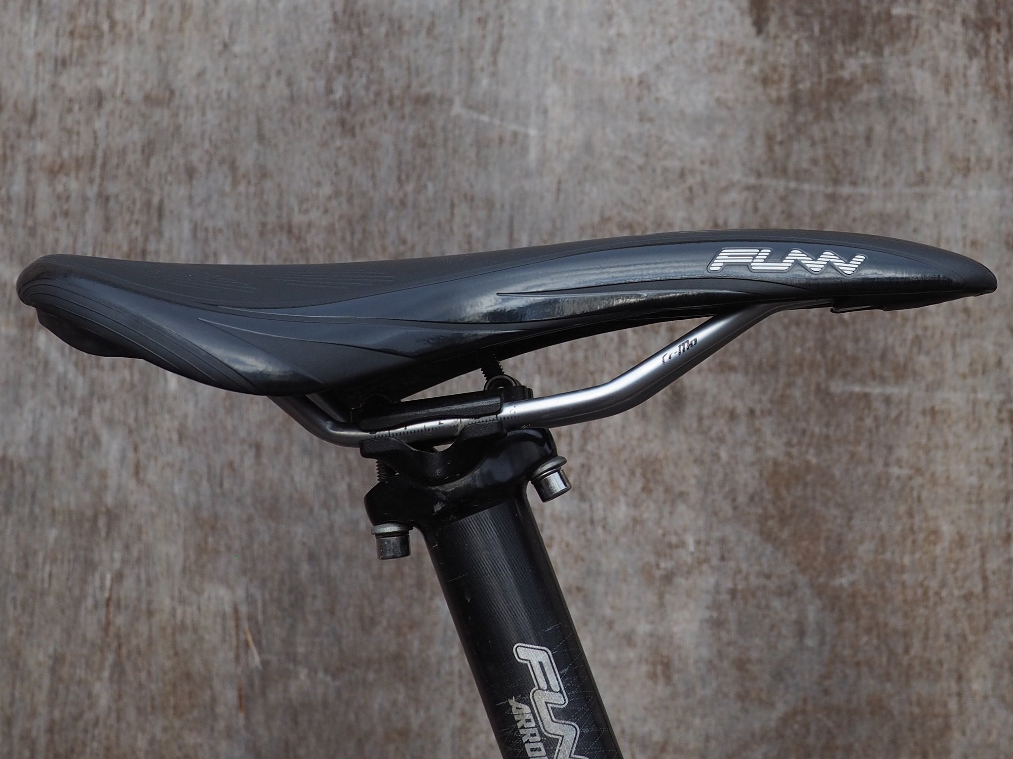 a close-up of a black Funn adlib saddle mounted on a bike seatpost.