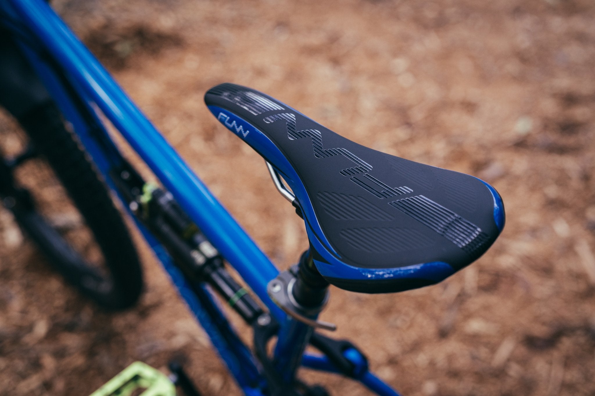 Funn adlib bike saddle securely mounted on a mountain bike, set against a outdoor background.