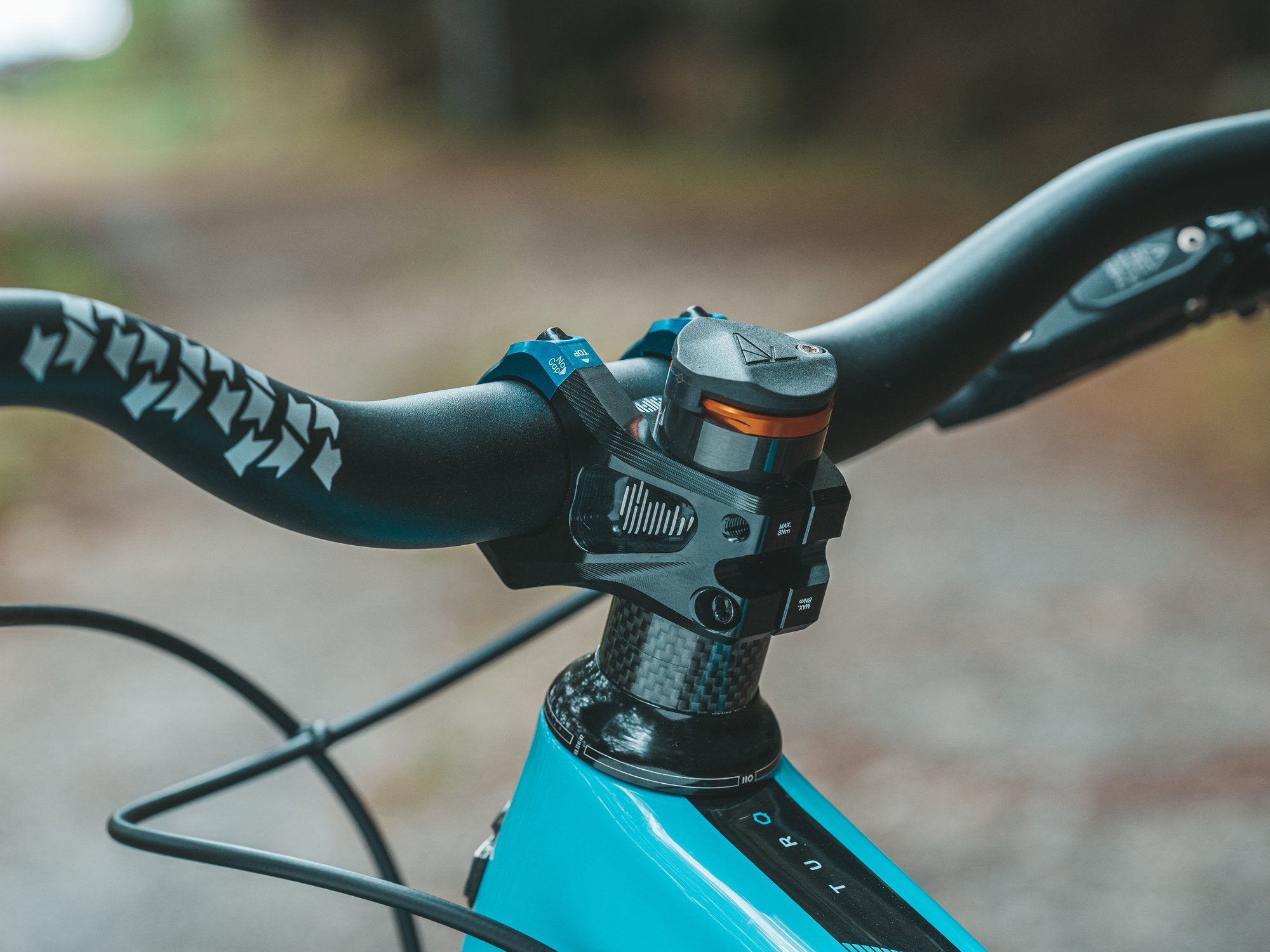 a mountain bike equipped with a black upturn handlebar and a blue equalizer zero stem