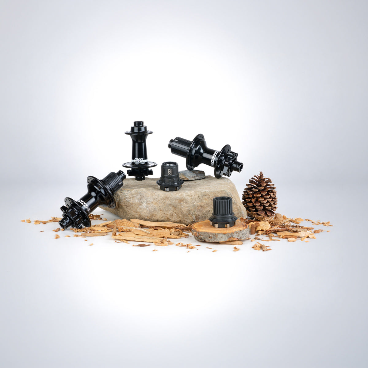 Funn hubs and interchangeable cassette bodies arranged on stone and wood