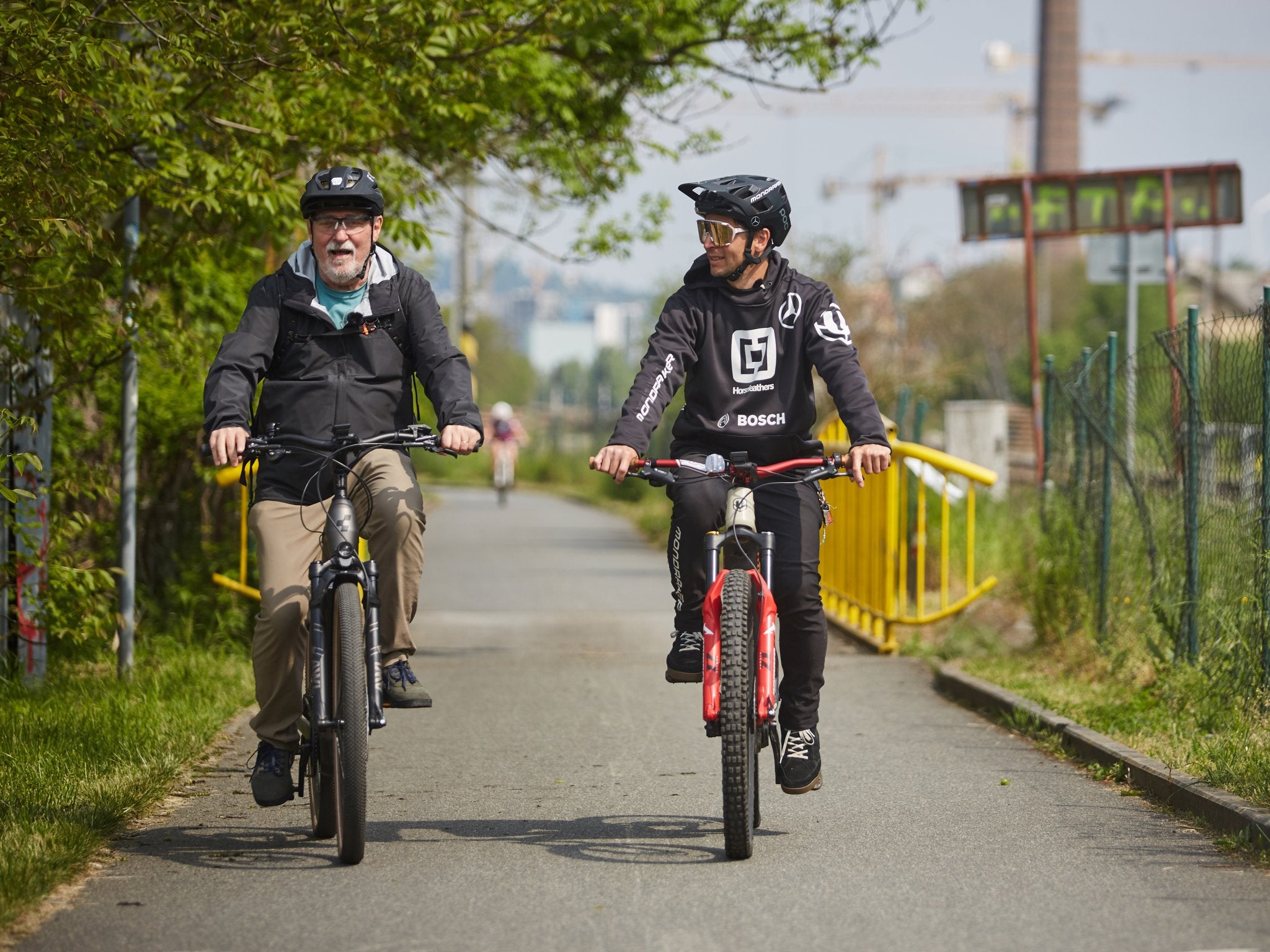 two riders are riding on city road happily