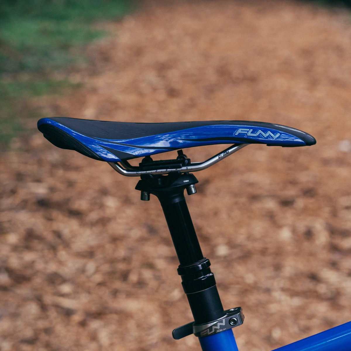 FUNN Adlib Saddle, slim blue and black bike seat with padded top and CrMo rails mounted on dropper post for trail riding