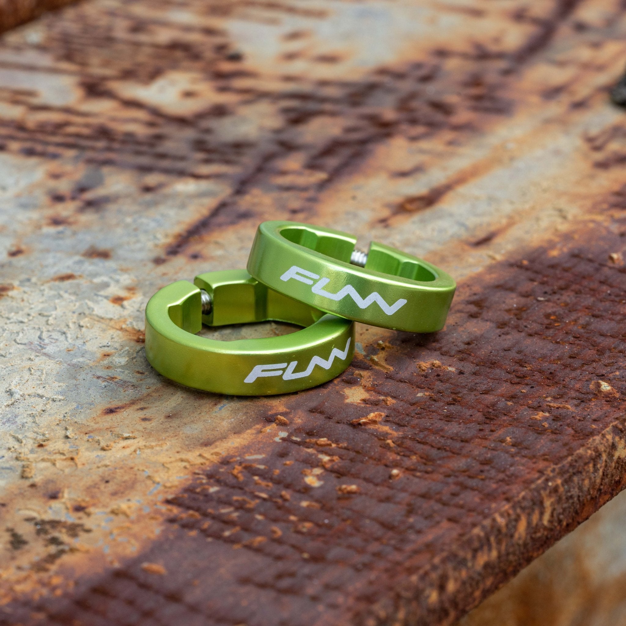Green FUNN alloy bike grip clamping rings for Hilt / Holeshot handlebars, slim round design on rustic metal surface