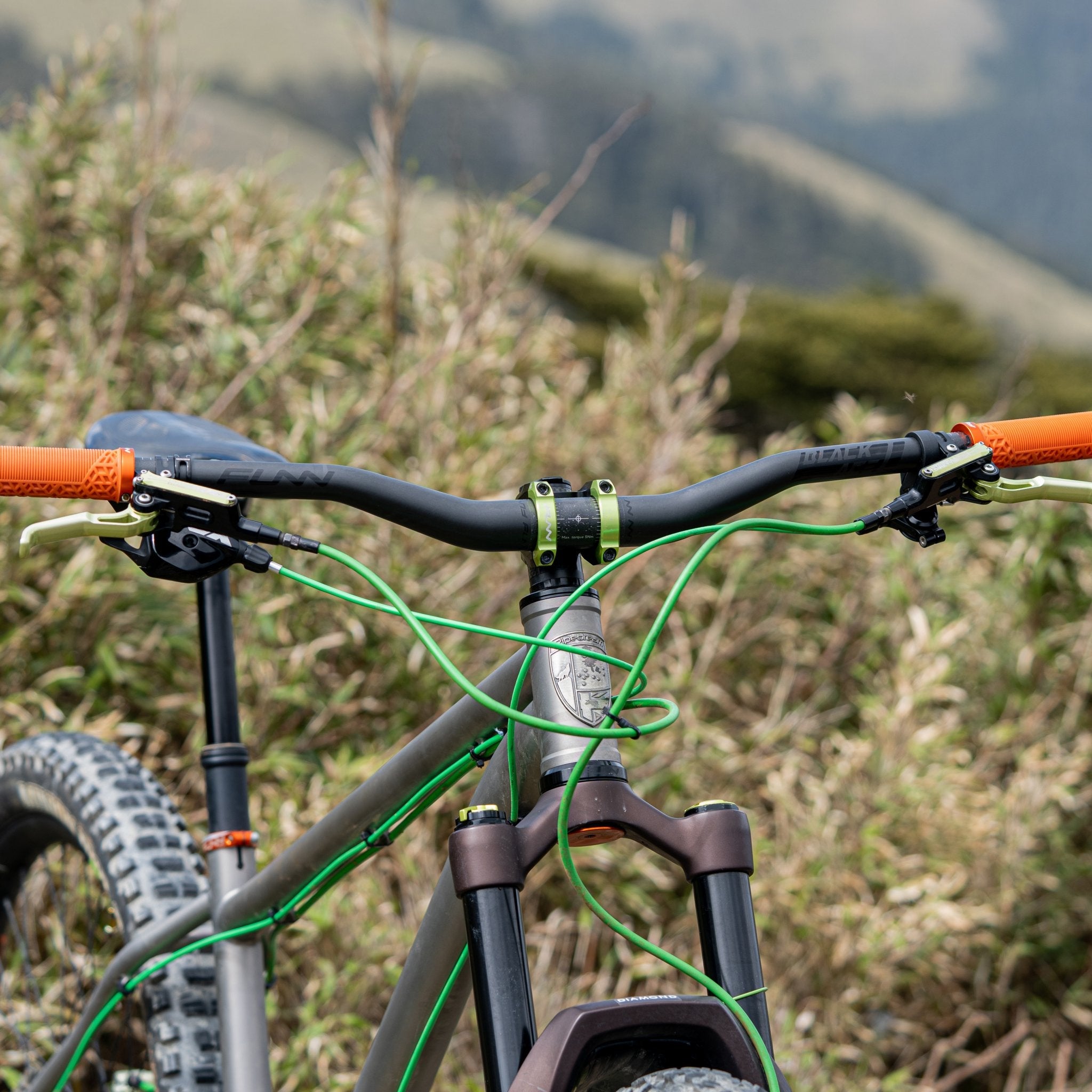 FUNN Black Ace carbon handlebar on mountain bike, black riser bar with orange grips for trail riding control 