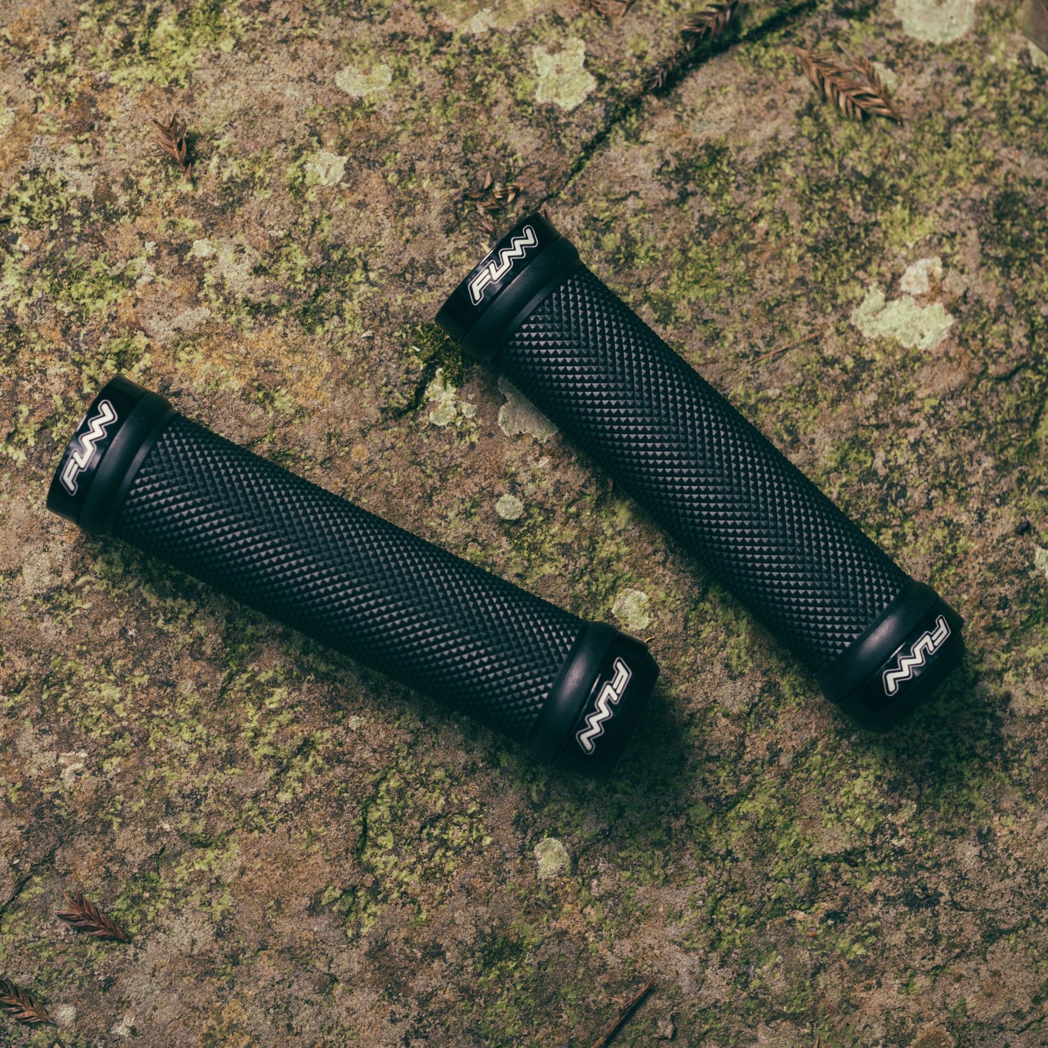 Black FUNN Combat I Lock-On Grips with textured rubber surface and alloy lock rings for secure mountain bike handlebar control