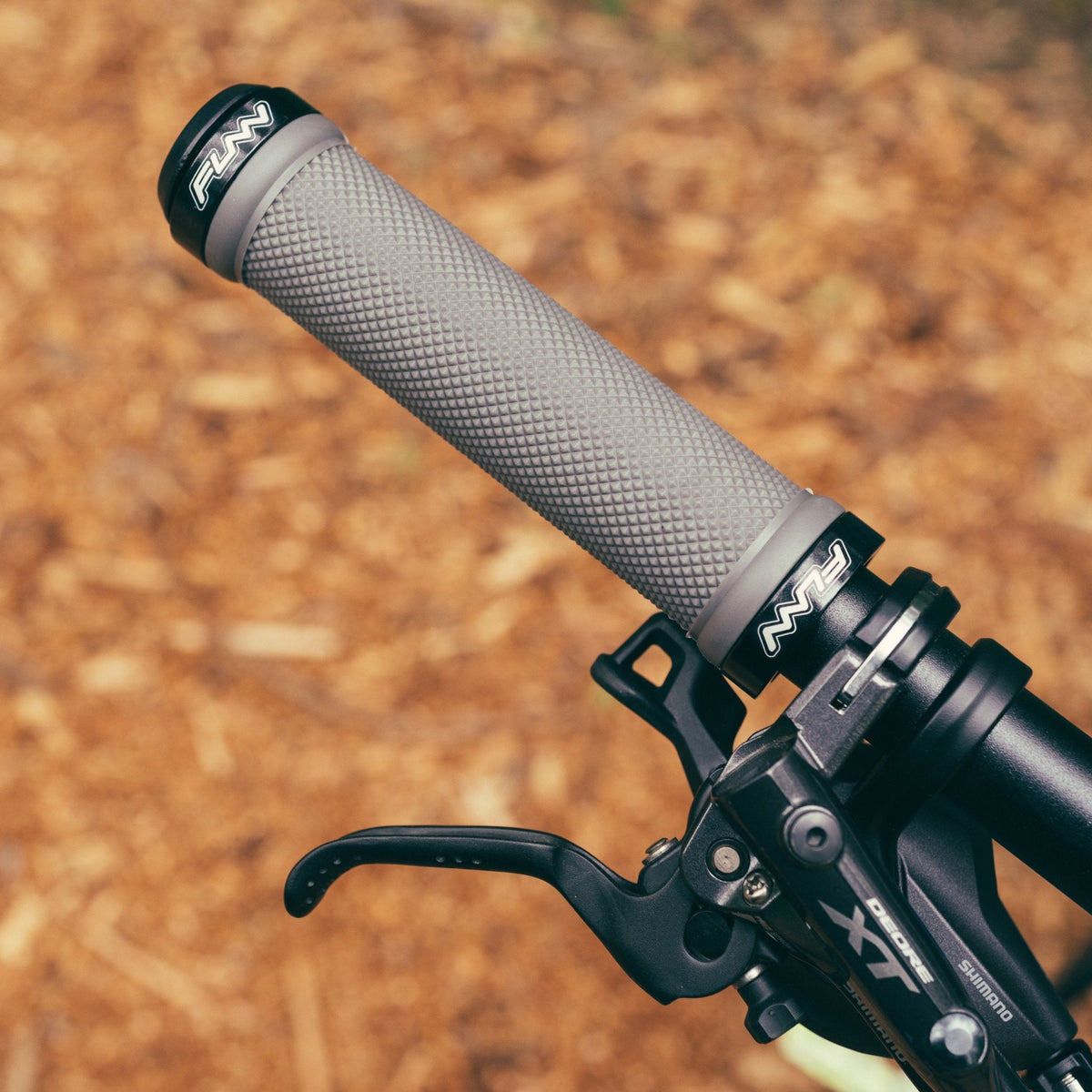 FUNN Combat I Lock-On Grips, grey textured rubber handlebar grips with black dual lock ring clamps for secure MTB control