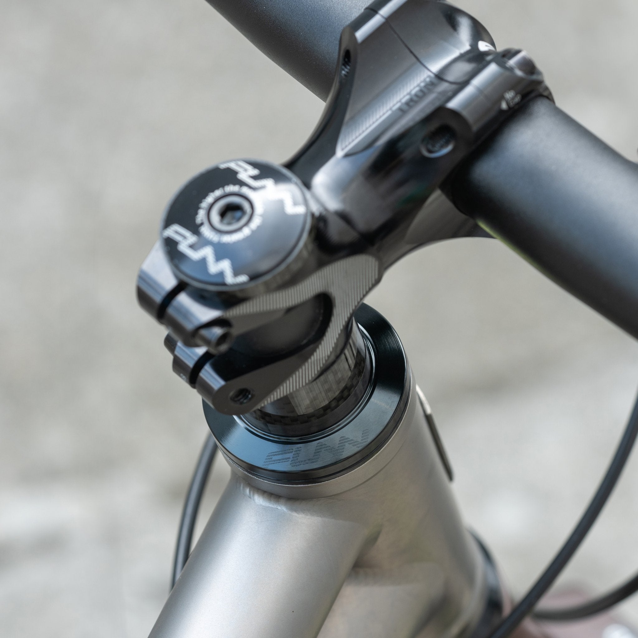 FUNN Descend Headset with Torn stem, black alloy mountain bike cockpit on silver frame for precise, durable steering control