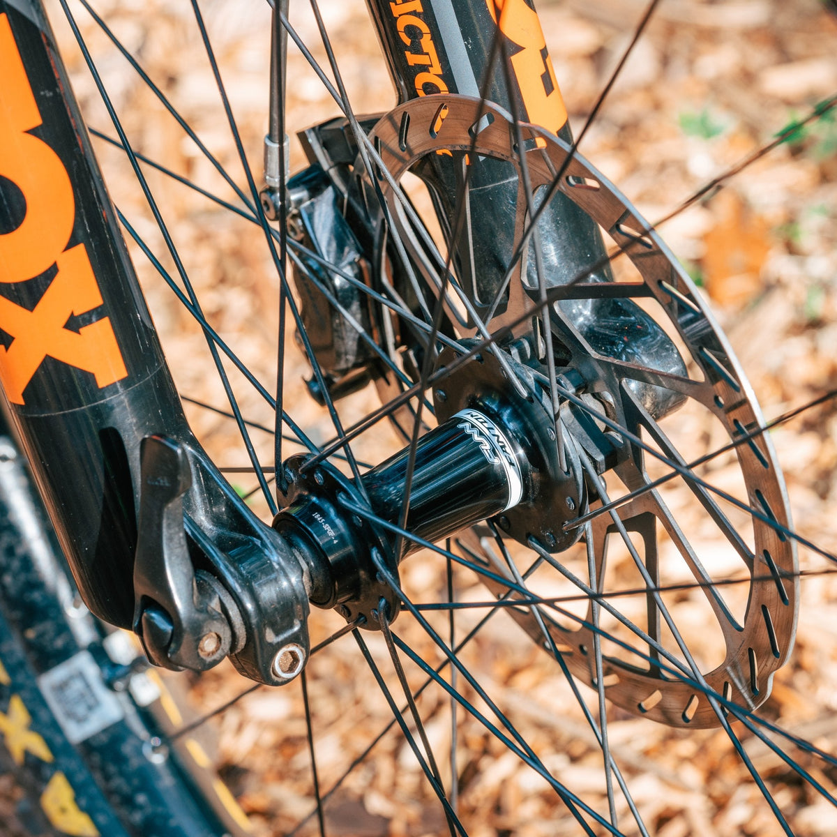 Black aluminum FUNN Fantom Hub Boost 15x110 front hub mounted with disc brake rotor and spokes on mountain bike fork