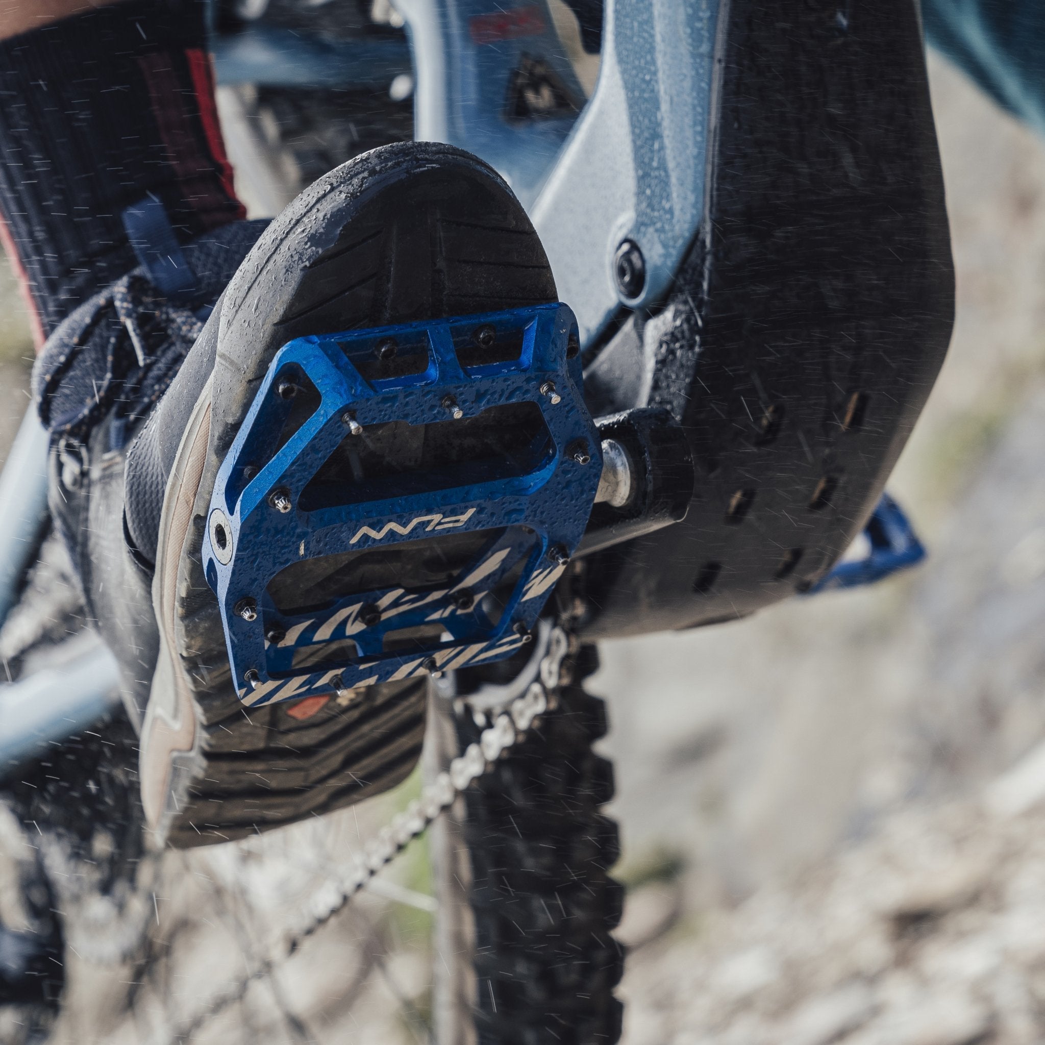 Blue aluminum FUNN Funndamental Flat Pedals on a mountain bike, wide grippy platform for secure trail riding traction