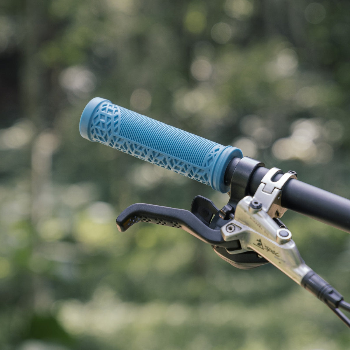 FUNN Hilt ES Slip-On Grips in light blue rubber on mountain bike handlebar, textured pattern for secure, comfortable control