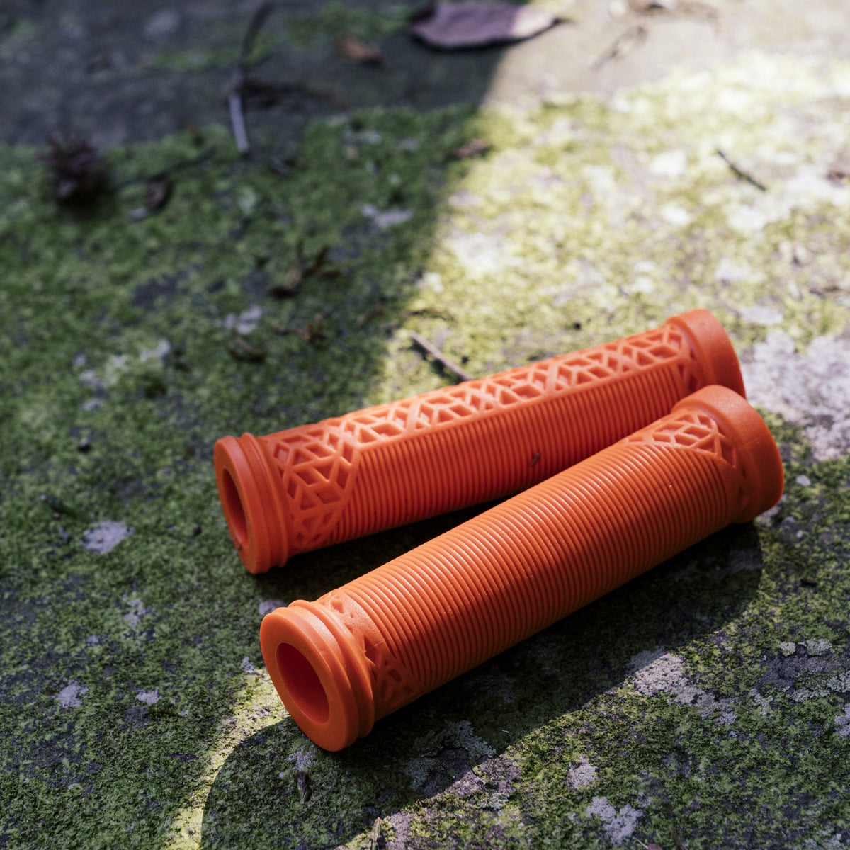 Orange FUNN Hilt ES Slip-On Grips with ribbed rubber texture and geometric ends for secure mountain bike handlebar control