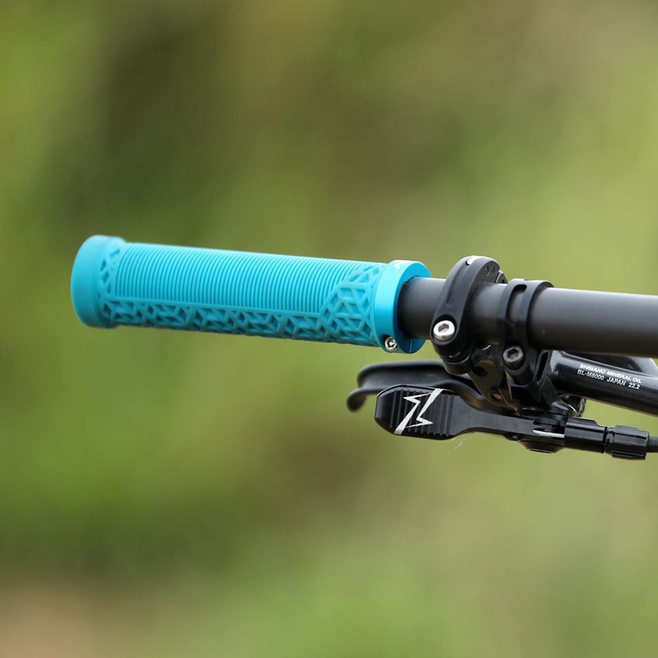 FUNN Hilt Lock-On Grips in teal on MTB handlebar, textured rubber pattern for secure, comfortable bike control