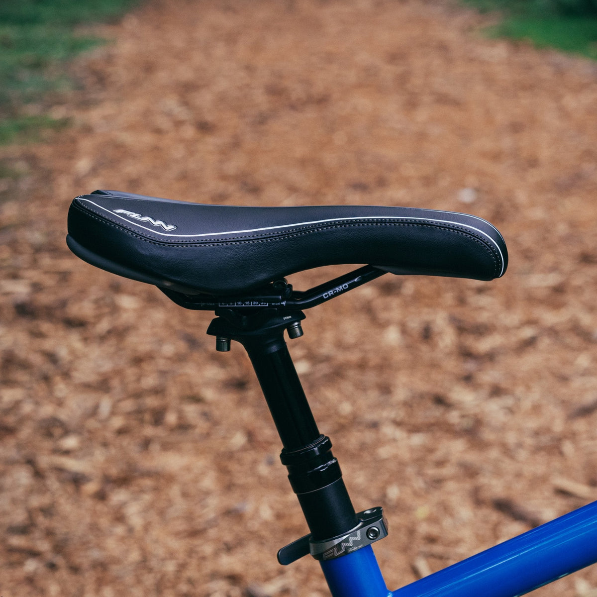 FUNN Launch II Saddle, sleek black ergonomic bike seat with white trim on alloy seatpost for trail and mountain riding