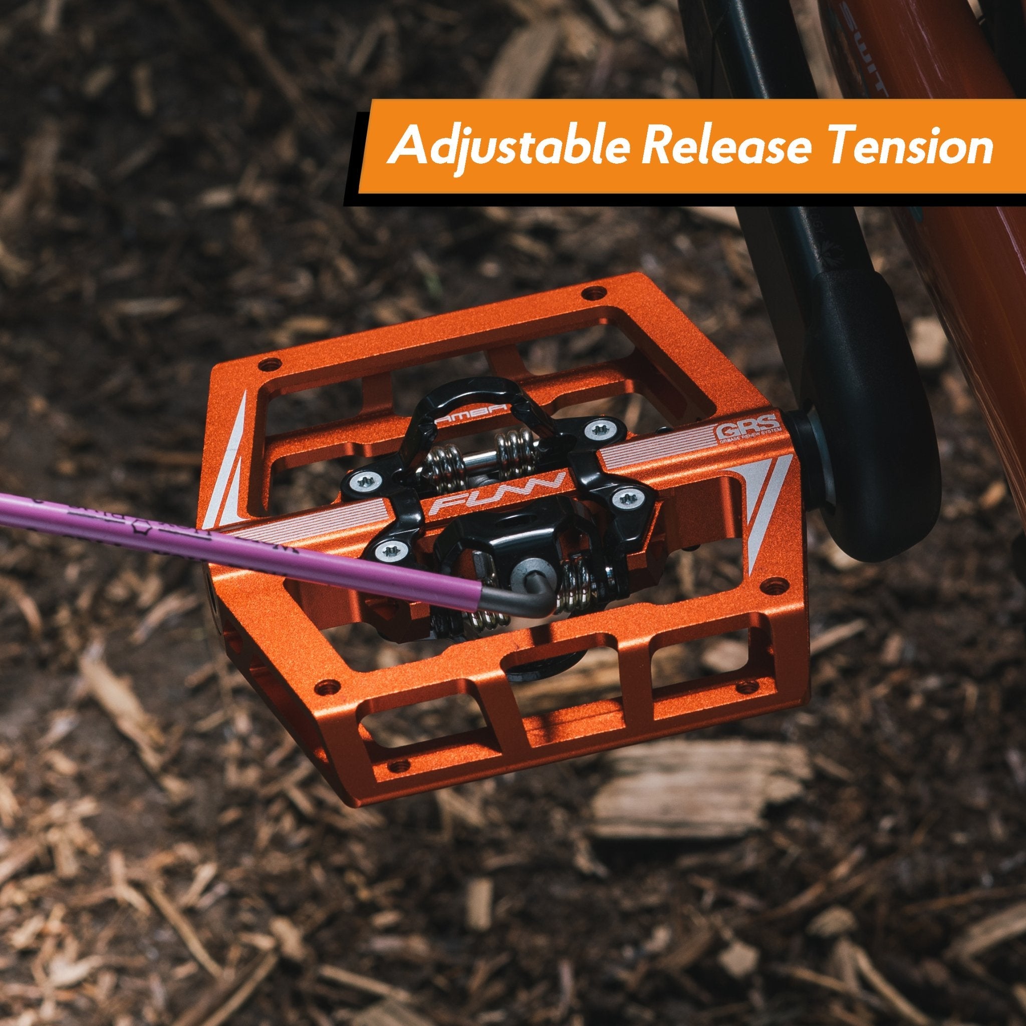 Orange FUNN Mamba Clip-In Pedals with wide alloy platform and adjustable release tension mounted on a mountain bike crank