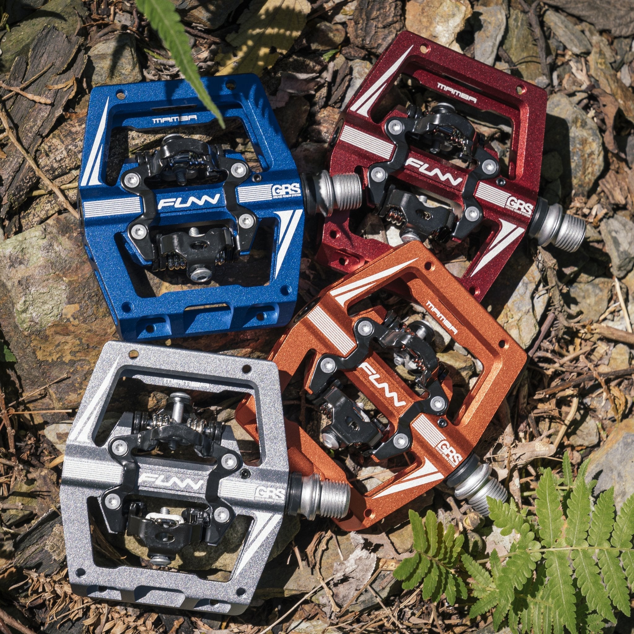 FUNN Mamba S Clip-In Pedals with smaller platform and GRS system, colorful alloy MTB clipless pedals on rocky trail background