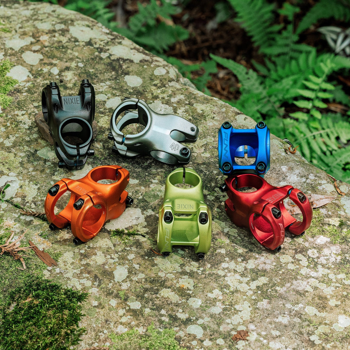 FUNN Nixie Stem anodized alloy bike stems in black, silver, blue, orange, green and red displayed on rock outdoors