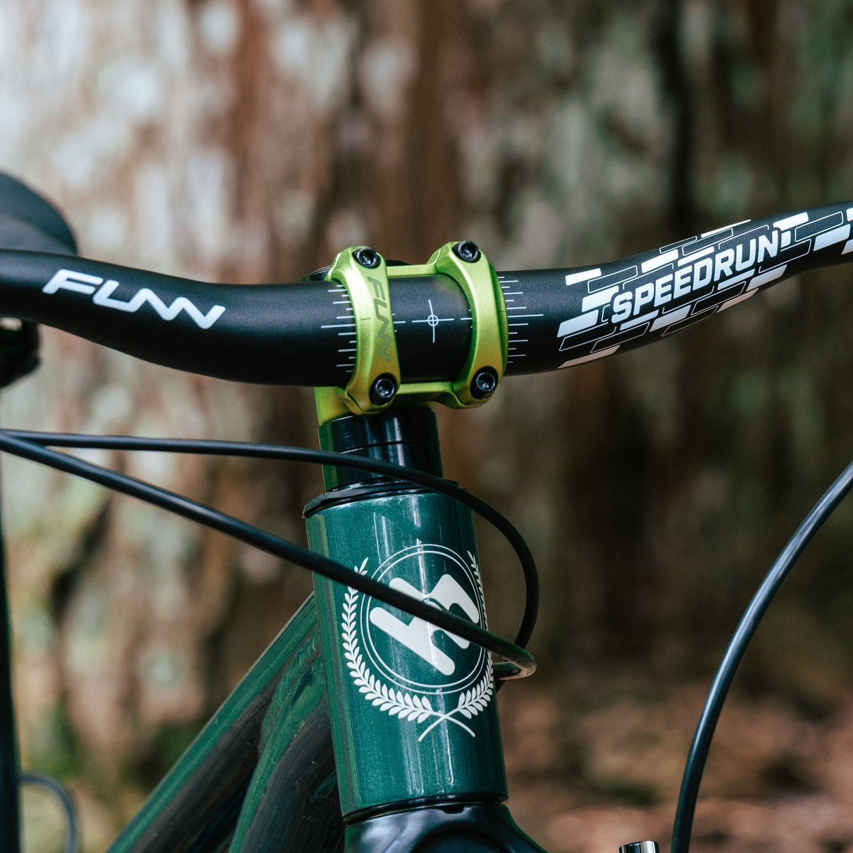 FUNN Nixie Stem with black Speedrun handlebar, alloy clamp in neon green mounted on dark green mountain bike front end
