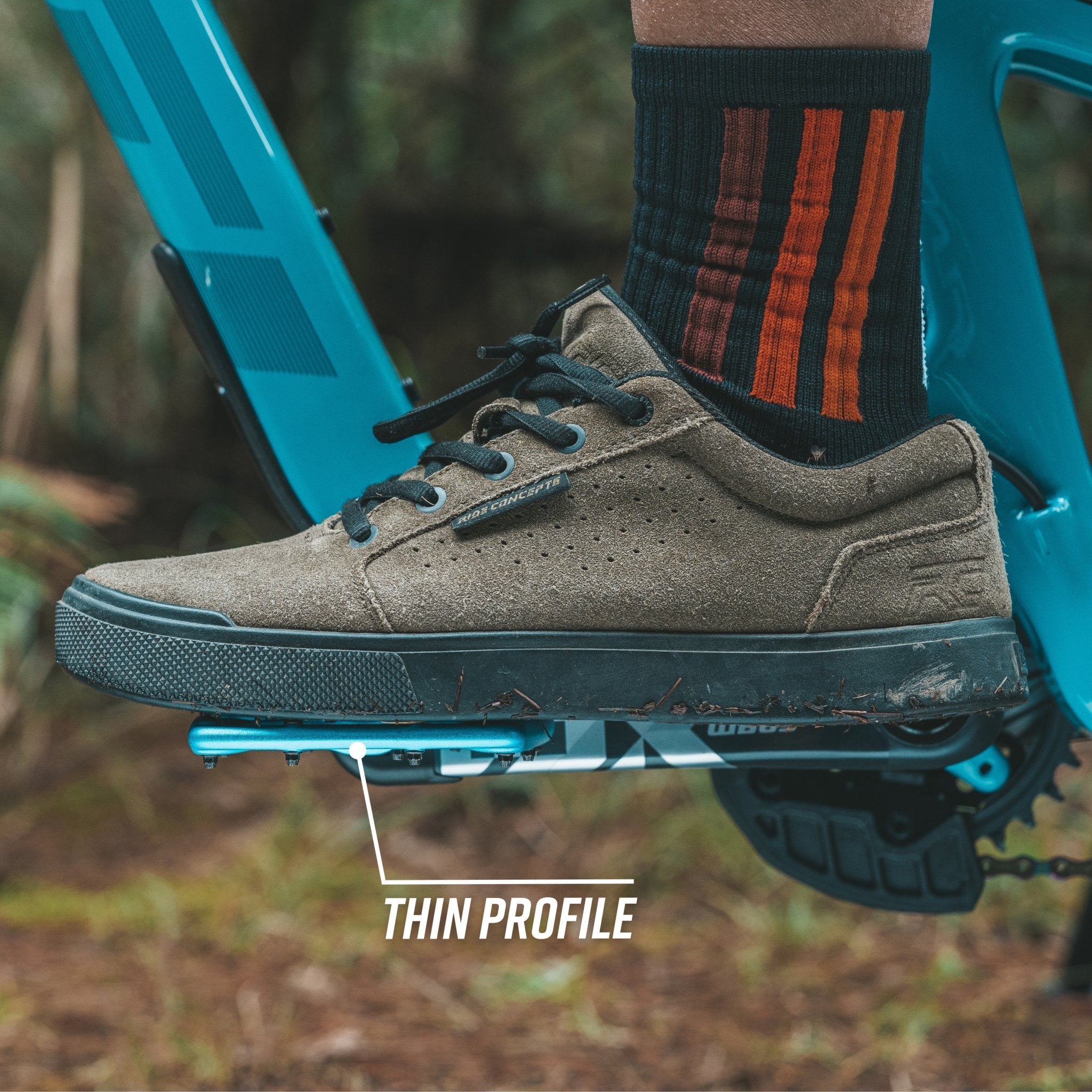 FUNN Python Flat Pedals with thin low-profile blue platform under MTB shoe on trail bike crank for secure grip