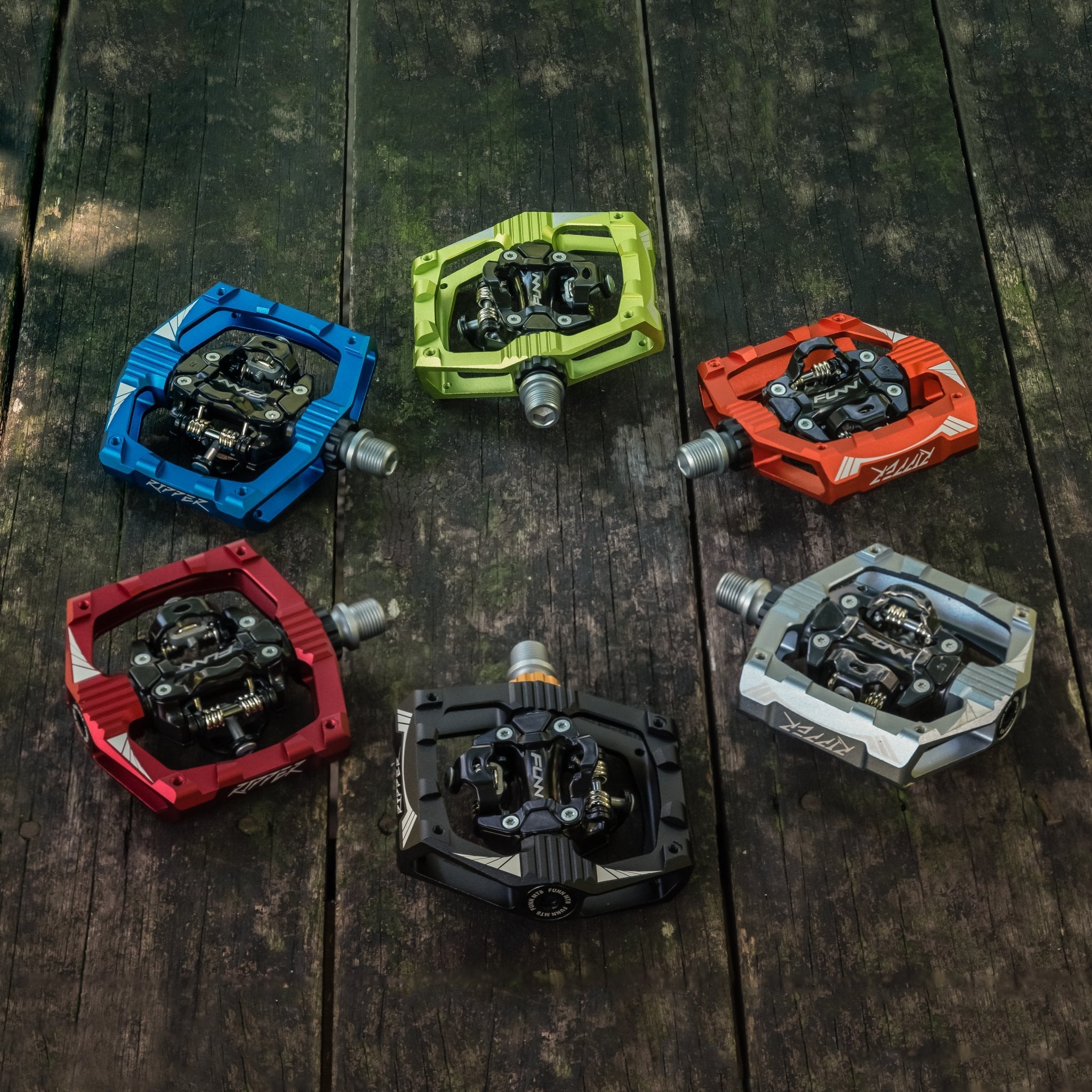 FUNN Ripper clip-in SPD pedals in colorful aluminum bodies, showcasing rugged platform shape and dual-sided locking mechanism
