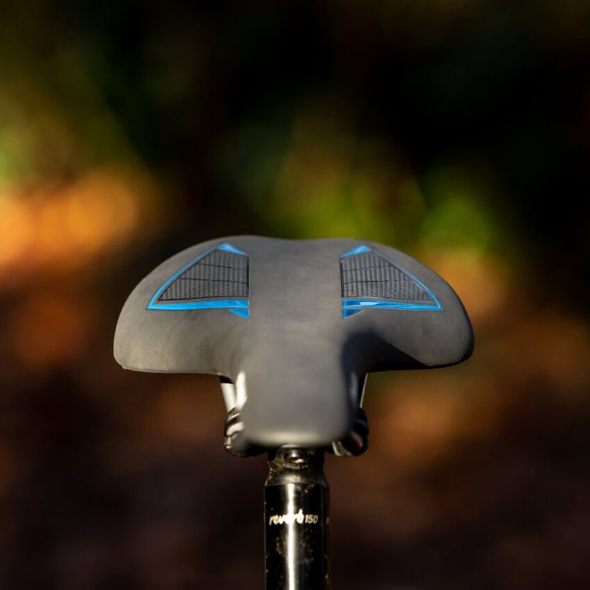 FUNN Skinny Saddle, sleek black bike seat with blue grip panels, slim ergonomic shape mounted on seatpost