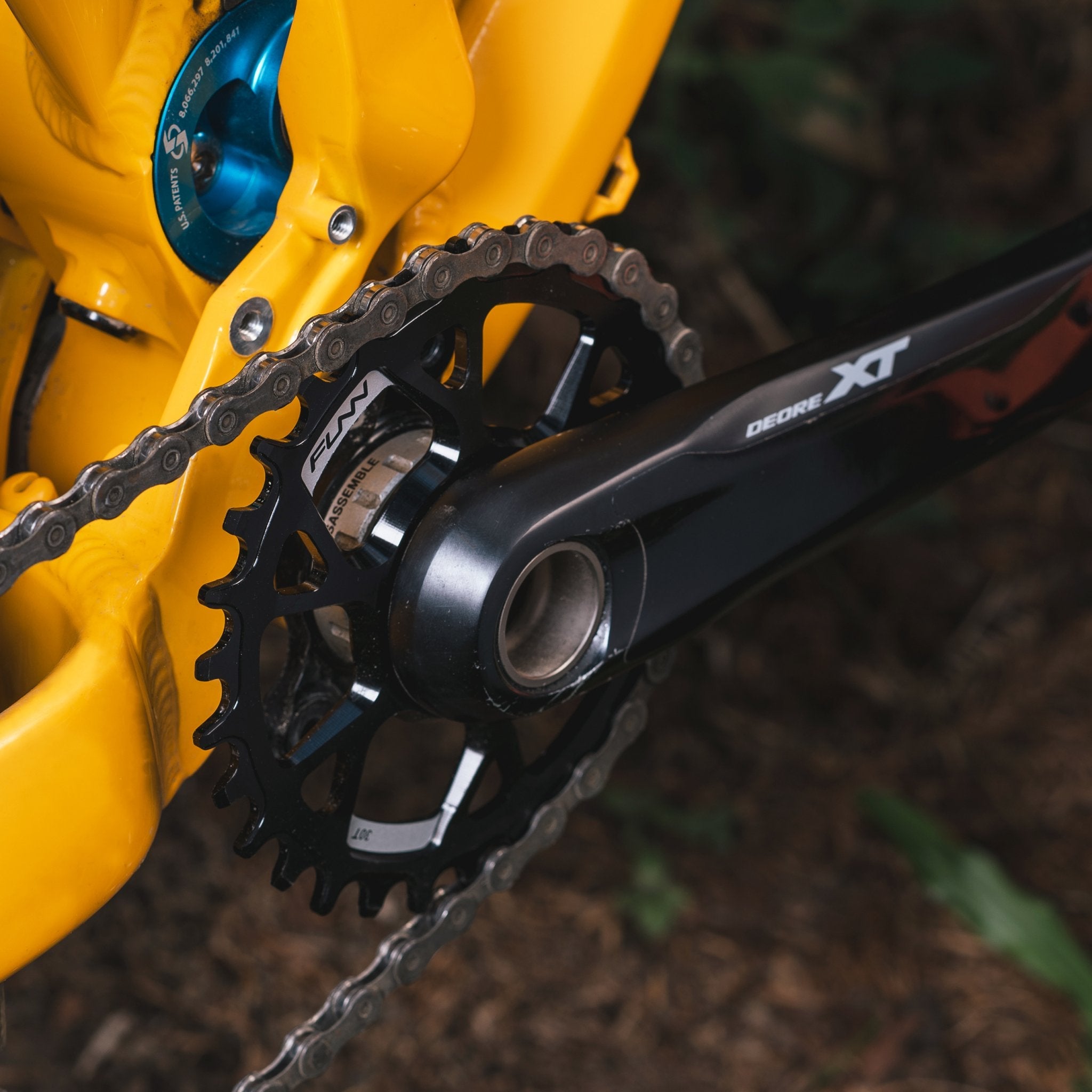 Black Solo DS Narrow-Wide Chainring by FUNN on Shimano direct-mount chainring system, alloy teeth on yellow mountain bike crank