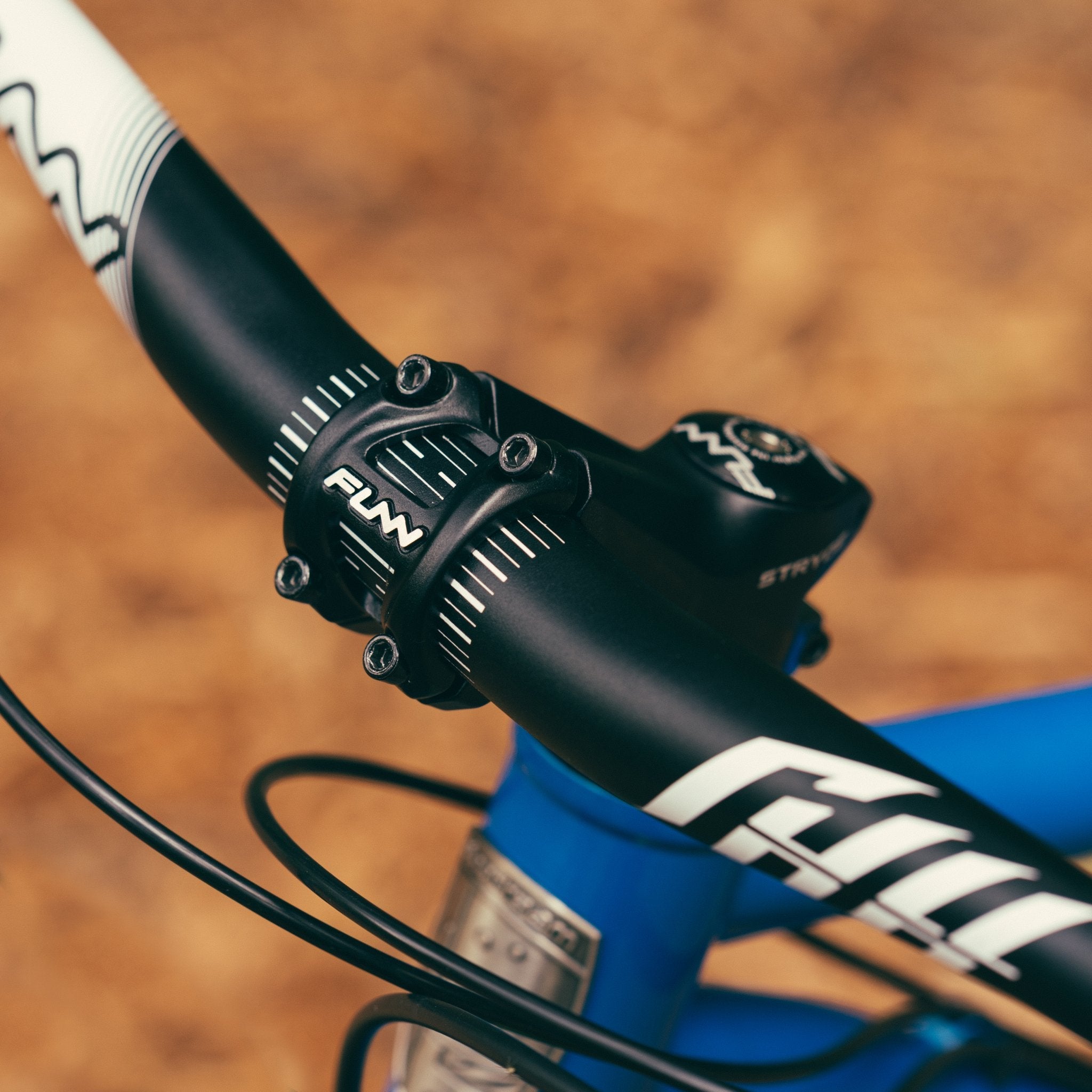 Black aluminum FUNN Stryge Riser Stem 60mm securely clamping flat handlebar on blue mountain bike for precise steering