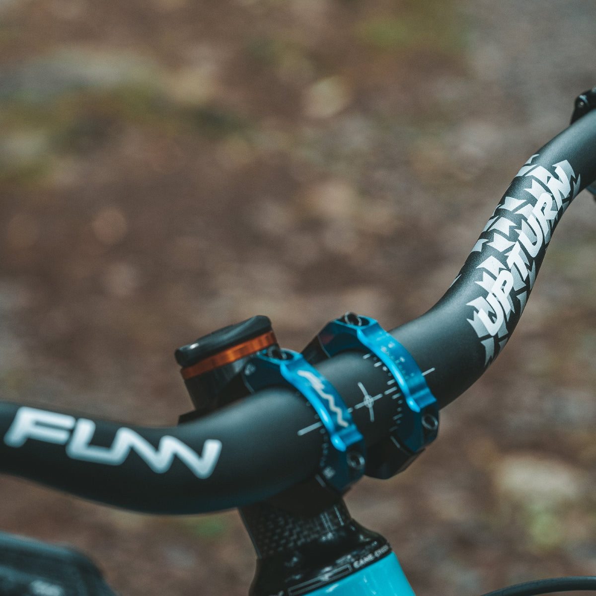 FUNN Upturn High Riser Handlebar, black alloy MTB bar with white graphics and blue clamps for precise trail control