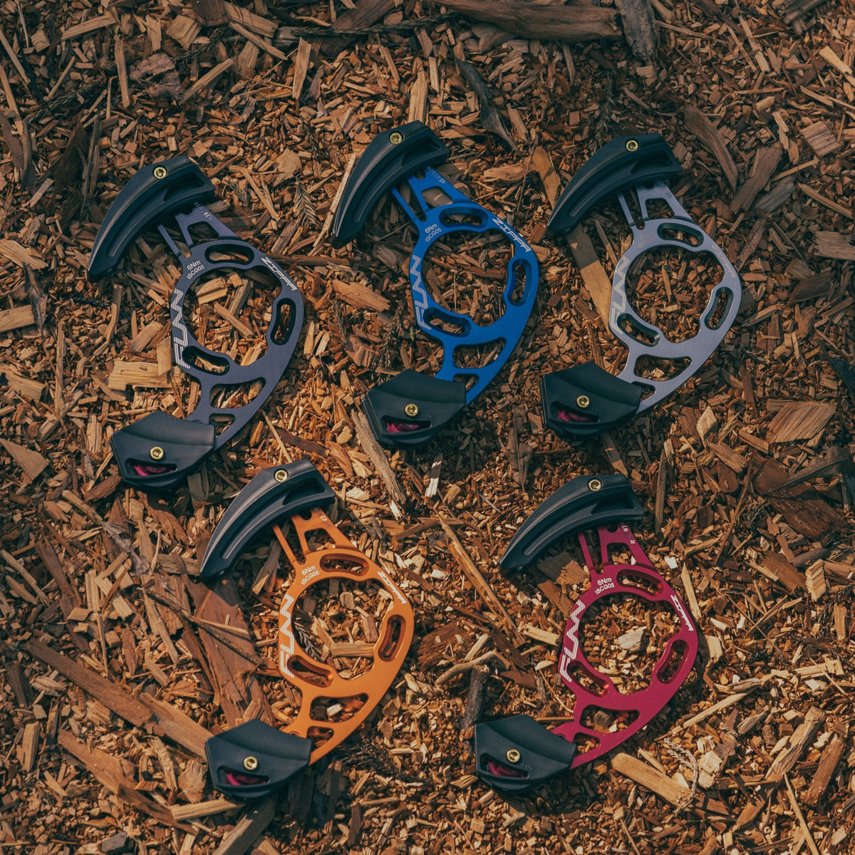 FUNN Zippa AM Chain Guide in multiple anodized colors, lightweight alloy MTB chain guard with black bash guard on wood chips