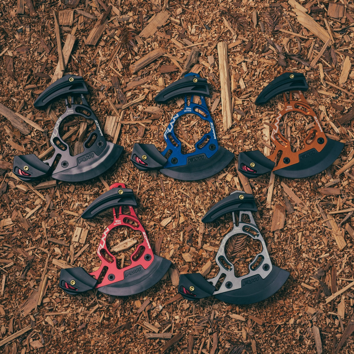 FUNN Zippa DH Chain Guide in red, blue, orange, grey and black, alloy bash guard for mountain bike chain protection on trail ground
