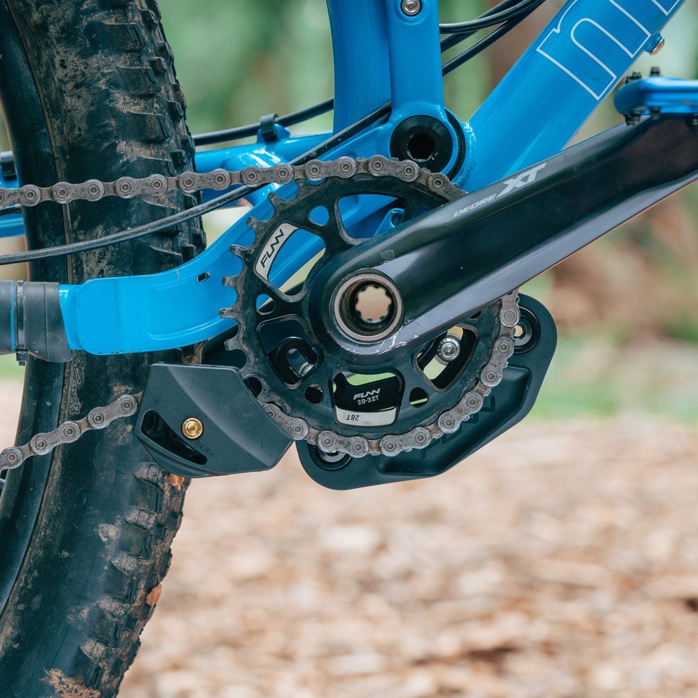 FUNN Zippa LG chain guide mounted on blue mountain bike, black alloy guard protecting chainring for secure drivetrain performance