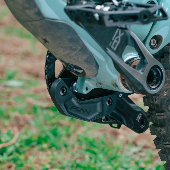 Black FUNN Zippa LG Chain Guide mounted on mountain bike frame, durable guard protecting chainring on rough trail terrain