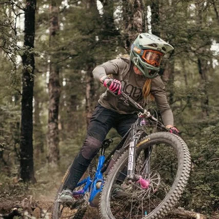 Person riding a mountain bike through a forest