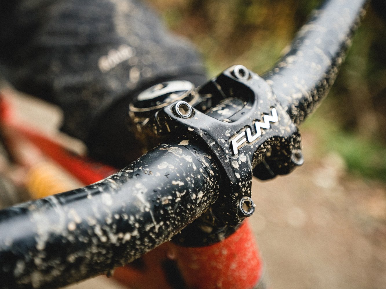 a muddy mountain bike equipped with a black funn crossfire bike stem