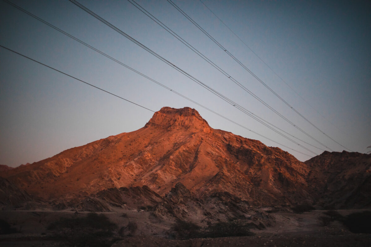 A mountain with power lines in the background.