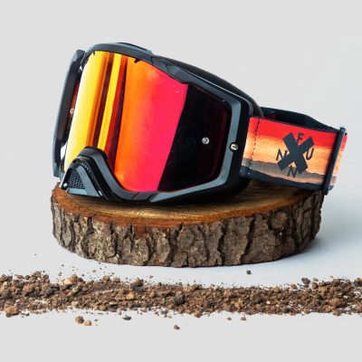 a pair of Soljam goggles sitting on top of a stump.
