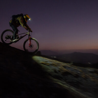 MTBer skillfully downhills a trail under the cover of night, showcasing daring FunnMTB action