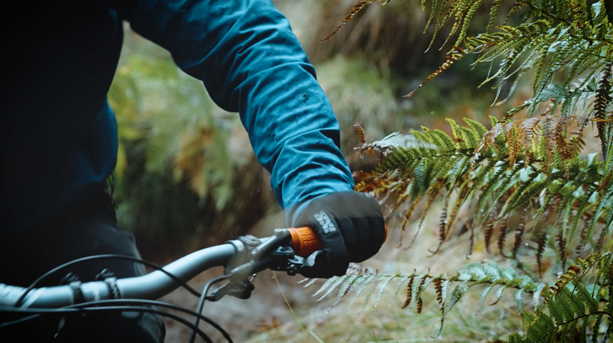 Close shot of a Funn rider's arm gripping Funn Holeshot bike grips while trail riding