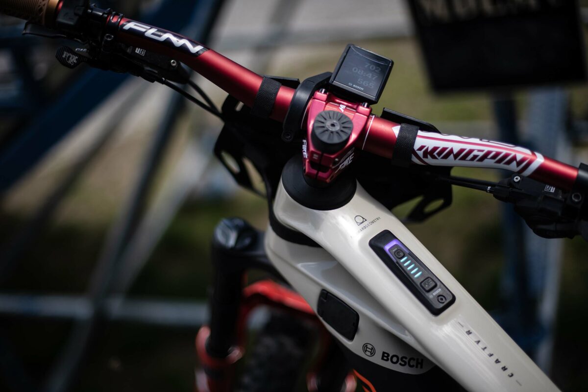 Close-up handlebar of a mountain bike being ridden by an E-Biker.