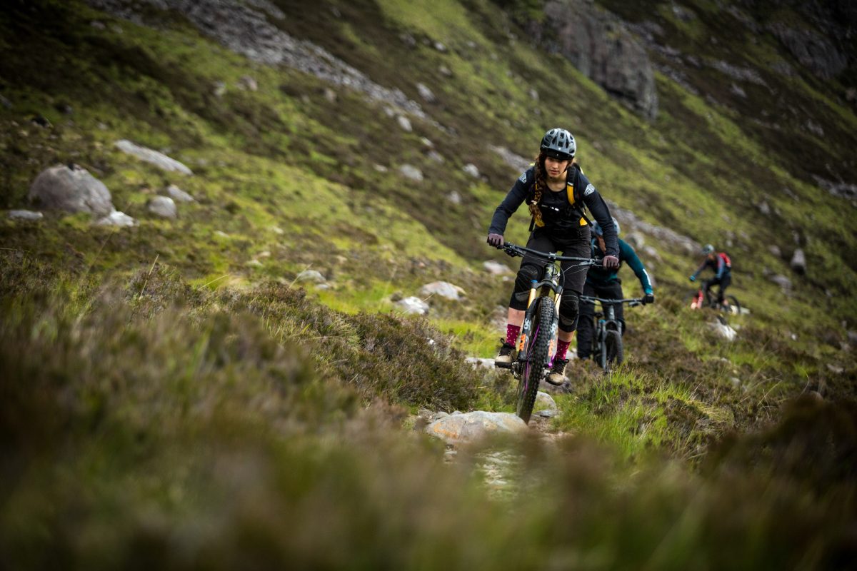 a group of mountain bikers on a trail in the scottish highlands 02
