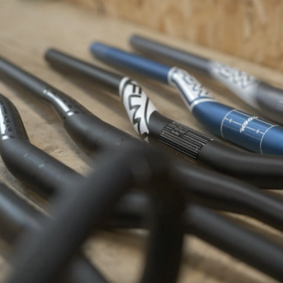 Close shot of a collection of Funn handlebars neatly lined on a wooden table