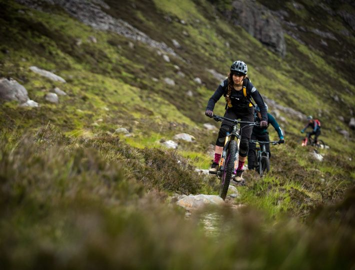 a group of mountain bikers on a trail in the scottish highlands 02