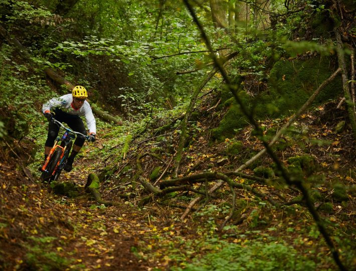 a person riding a mountain bike through the woods 02