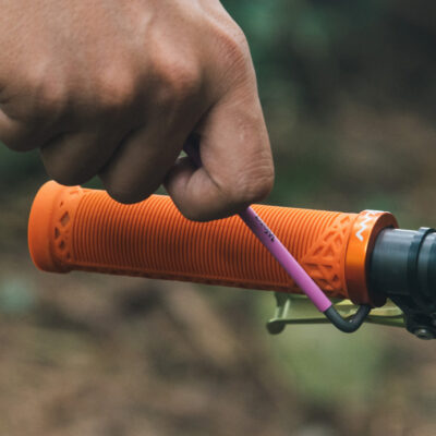 tighten the bolt of a orange hilt single lock on bike grip